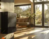 Un radiateur basse consommation noir, moderne, est fixé au mur d'un salon lumineux.