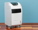 Climatiseur mobile 15000 BTU blanc sur roulettes, avec écran LED bleu affichant la température. Idéal pour rafraîchir votre intérieur.