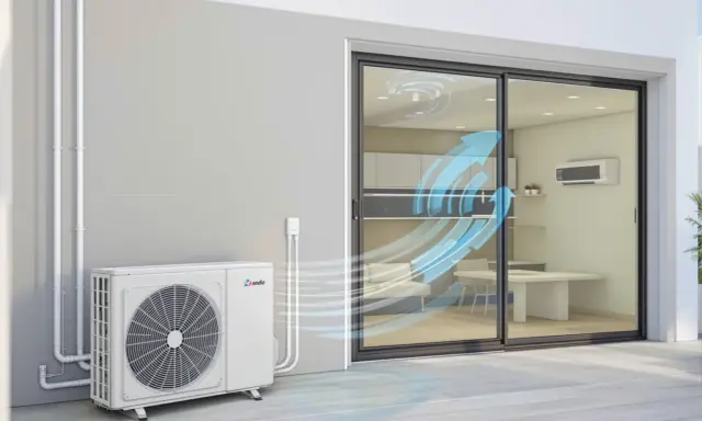 Unité extérieure d'un système de chauffage clim réversible, diffusant de l'air frais dans une pièce par une baie vitrée.